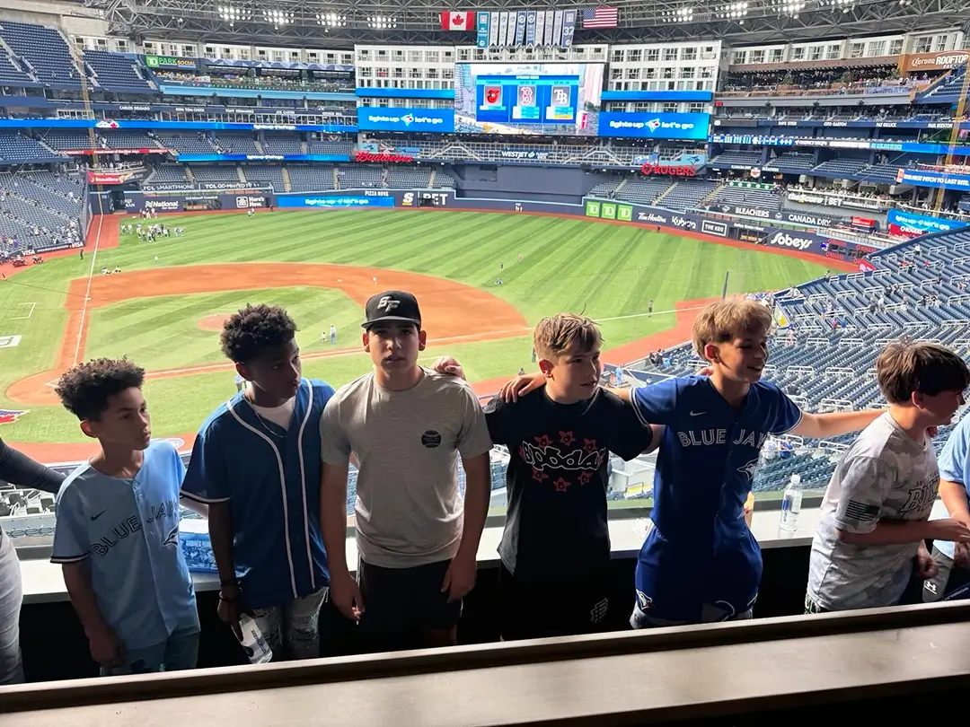 Midtown_Monarchs_teammates_T Midtown Monarchs team mates on tour, standing in a baseball stadium